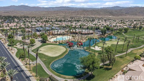 A bird's eye view of a resort with a pool and a golf course.