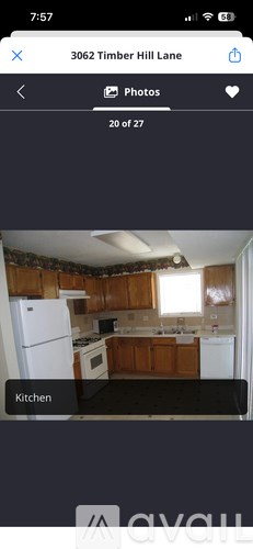 A kitchen with wooden cabinets and white appliances.