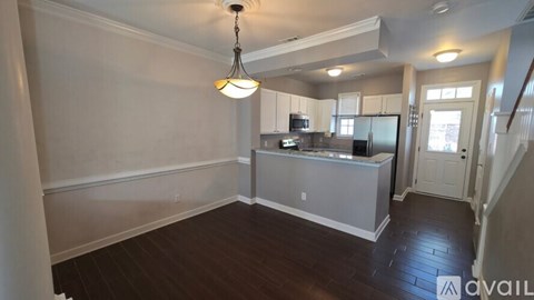A kitchen with a refrigerator, microwave, and oven is available for rent.