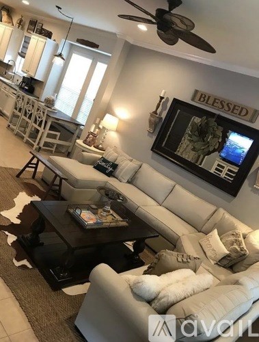 A living room with a black coffee table and a white couch.