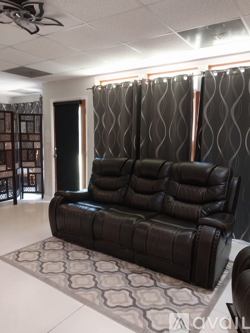 A black leather sofa in a living room.