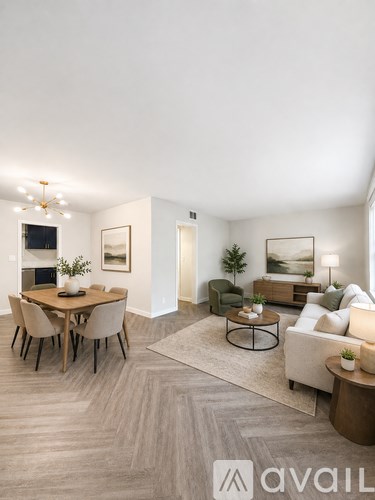 A living room with a dining table and chairs, a couch, and a coffee table.