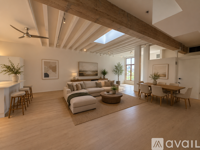 A spacious living room with wooden floors and furniture.