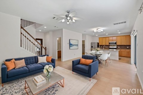 A living room with a blue couch and a coffee table.