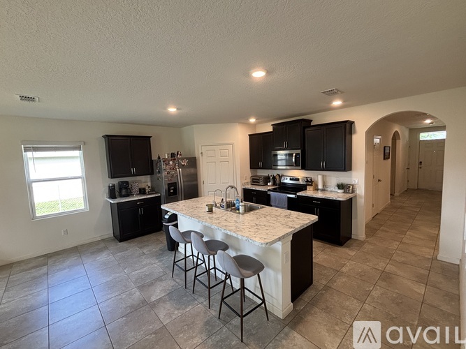 A kitchen with a bar area and a dining area.