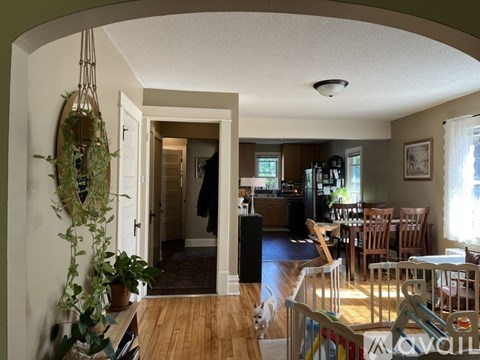 A living room with a dining table and chairs.