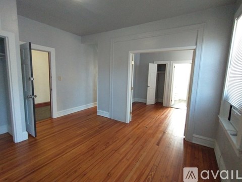 A room with wooden floors and white walls.