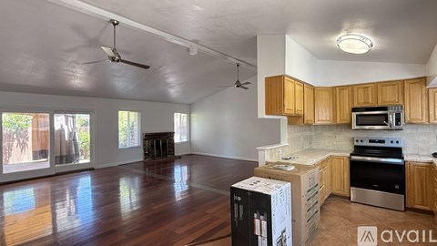 A kitchen with wooden cabinets and a stove top oven.