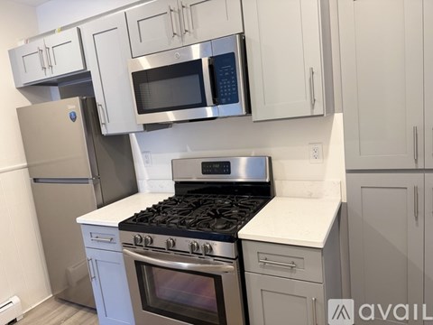 A kitchen with white cabinets and stainless steel appliances.