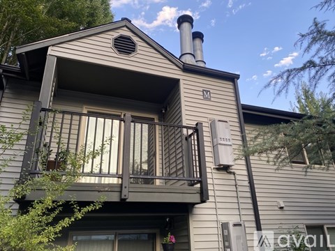 A house with a balcony and a chimney.