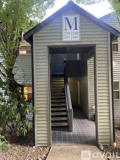 A small building with a sign that reads M 239 240 139 140.