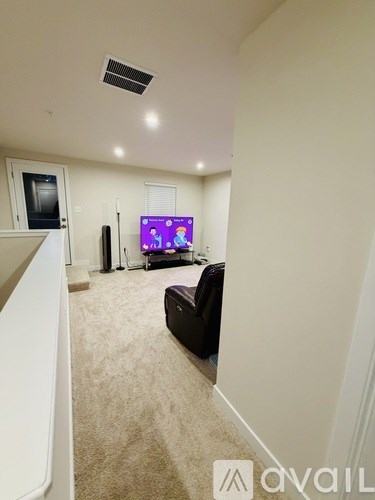 A living room with a couch and a television.