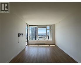A room with a large window overlooking a cityscape.