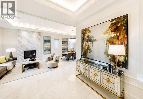 A living room with a fireplace and a painting on the wall.