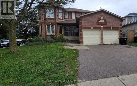 A red brick house with a white garage door is for sale.