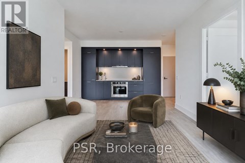 A modern living room with a sofa, armchair, and a coffee table.