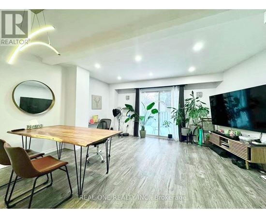 A modern living room with a wooden table and chairs.