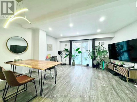 A modern living room with a wooden table and chairs.