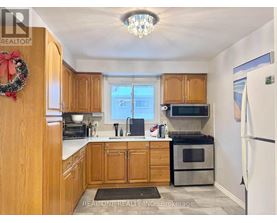 A kitchen with wooden cabinets and a wreath on the door.