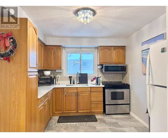 A kitchen with wooden cabinets and a wreath on the door.