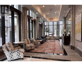 A large, well-lit lobby with a red carpet and comfortable seating.