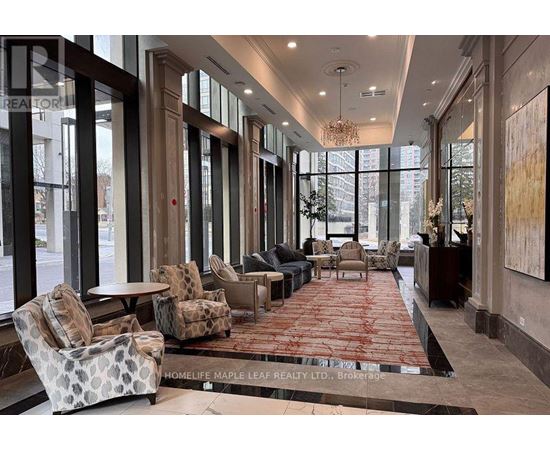 A large, well-lit lobby with a red carpet and comfortable seating.