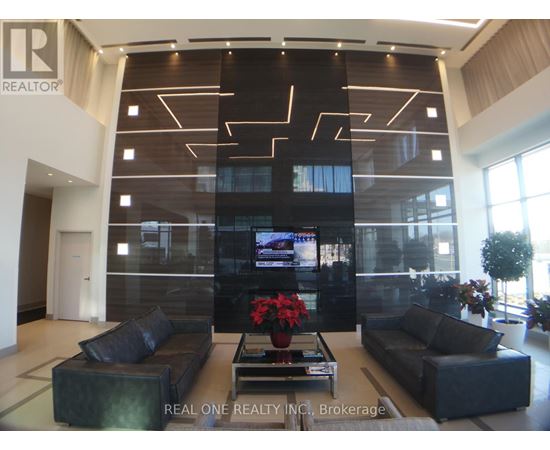 A modern living room with a large TV and comfortable seating.