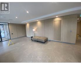 A spacious room with a bench in the middle and a window on the left.