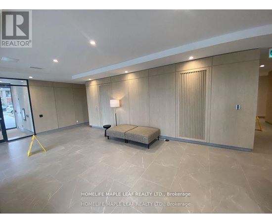 A spacious room with a bench in the middle and a window on the left.