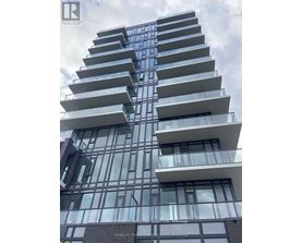 A tall residential building with balconies on each floor.