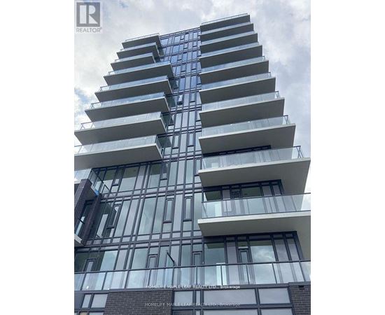 A tall residential building with balconies on each floor.