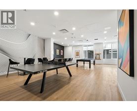 A conference room with a table and chairs and a painting on the wall.
