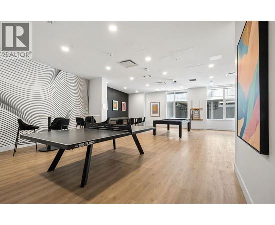 A conference room with a table and chairs and a painting on the wall.