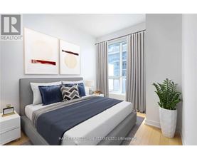 A bedroom with a large bed and a potted plant.
