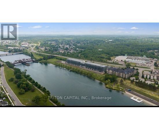 A bird's eye view of a city with a river running through it and a bridge crossing the river.