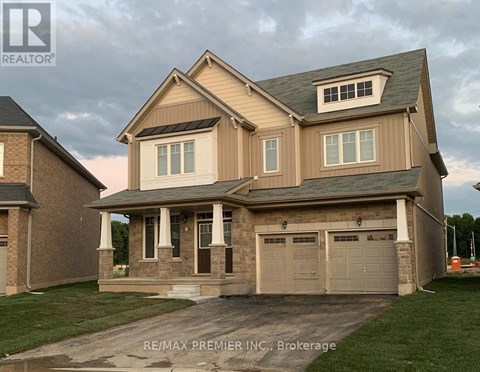 A two-story house with a garage is shown in the image.