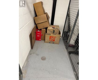 A pile of cardboard boxes are stacked in a corner.