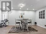 A dining room with a table and chairs.
