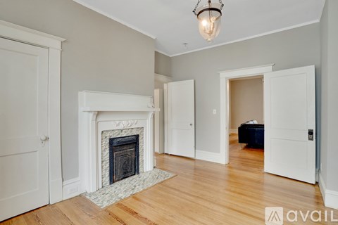 A living room with a fireplace and a couch in the background.