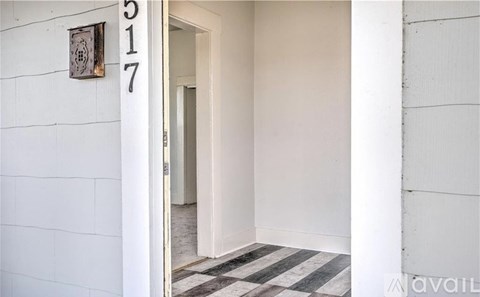 A white door is open to a hallway.