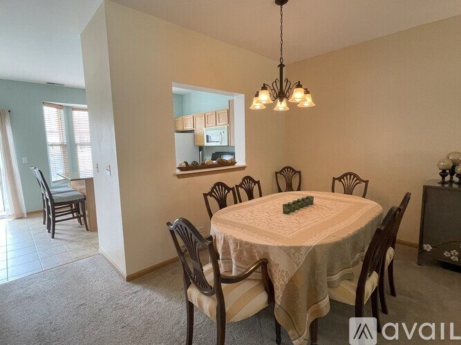 A dining room with a round table set for six.