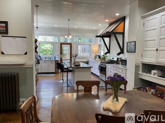 A kitchen with a table and chairs in the middle of the room.