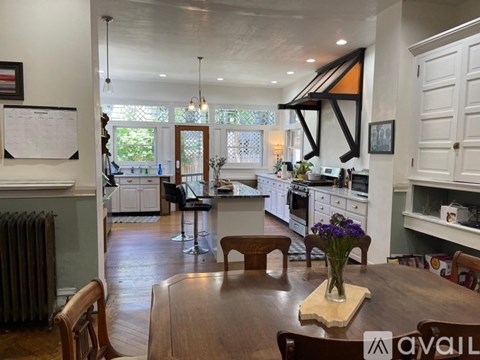 A kitchen with a table and chairs in the middle of the room.