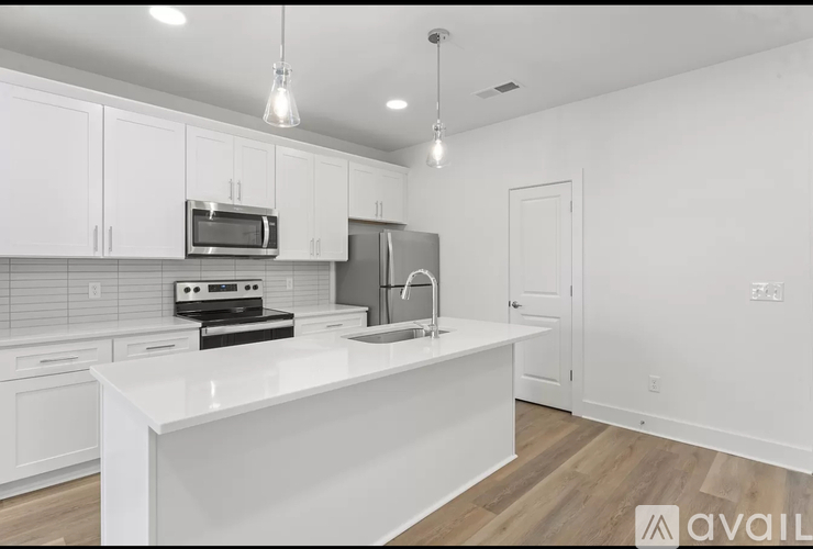A kitchen with white cabinets and appliances.