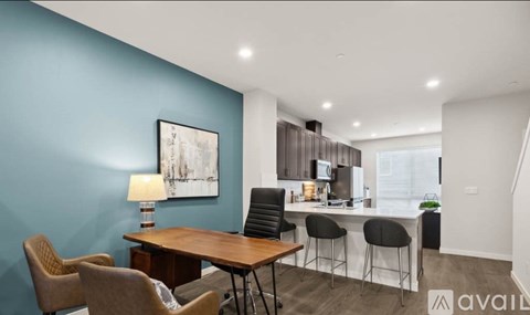 A modern kitchen with a dining table and chairs.
