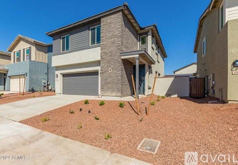 A house with a grey garage door is in front of a wall with a sign that says "AVAILABLE".