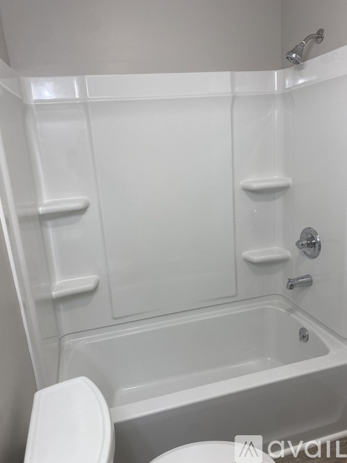 A white bathroom with a toilet and a bathtub.