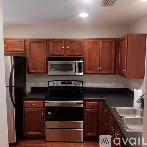 A kitchen with wooden cabinets and stainless steel appliances.