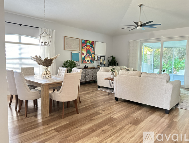 A living room with a dining table and chairs.