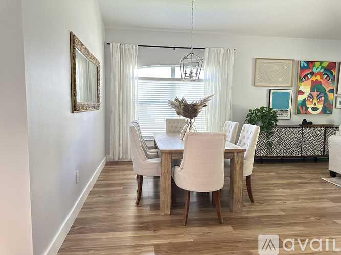 A dining room with a wooden table and chairs.